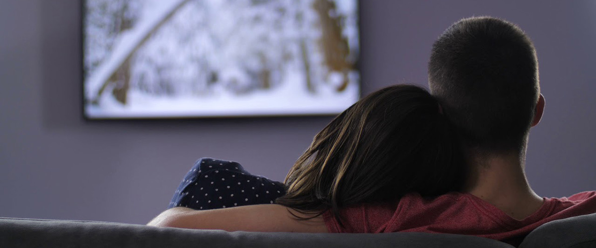 Couple watching television together