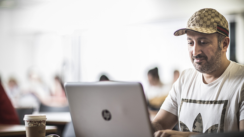 Man with a laptop and a coffee