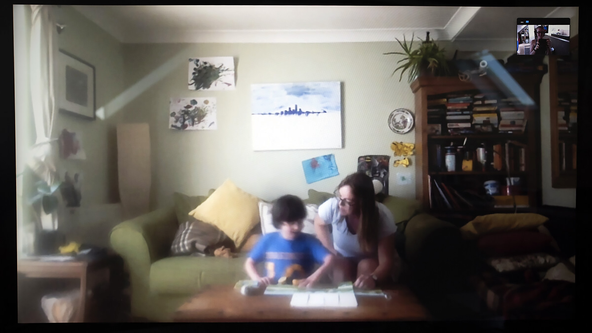 Ali Reading to her son on the sofa