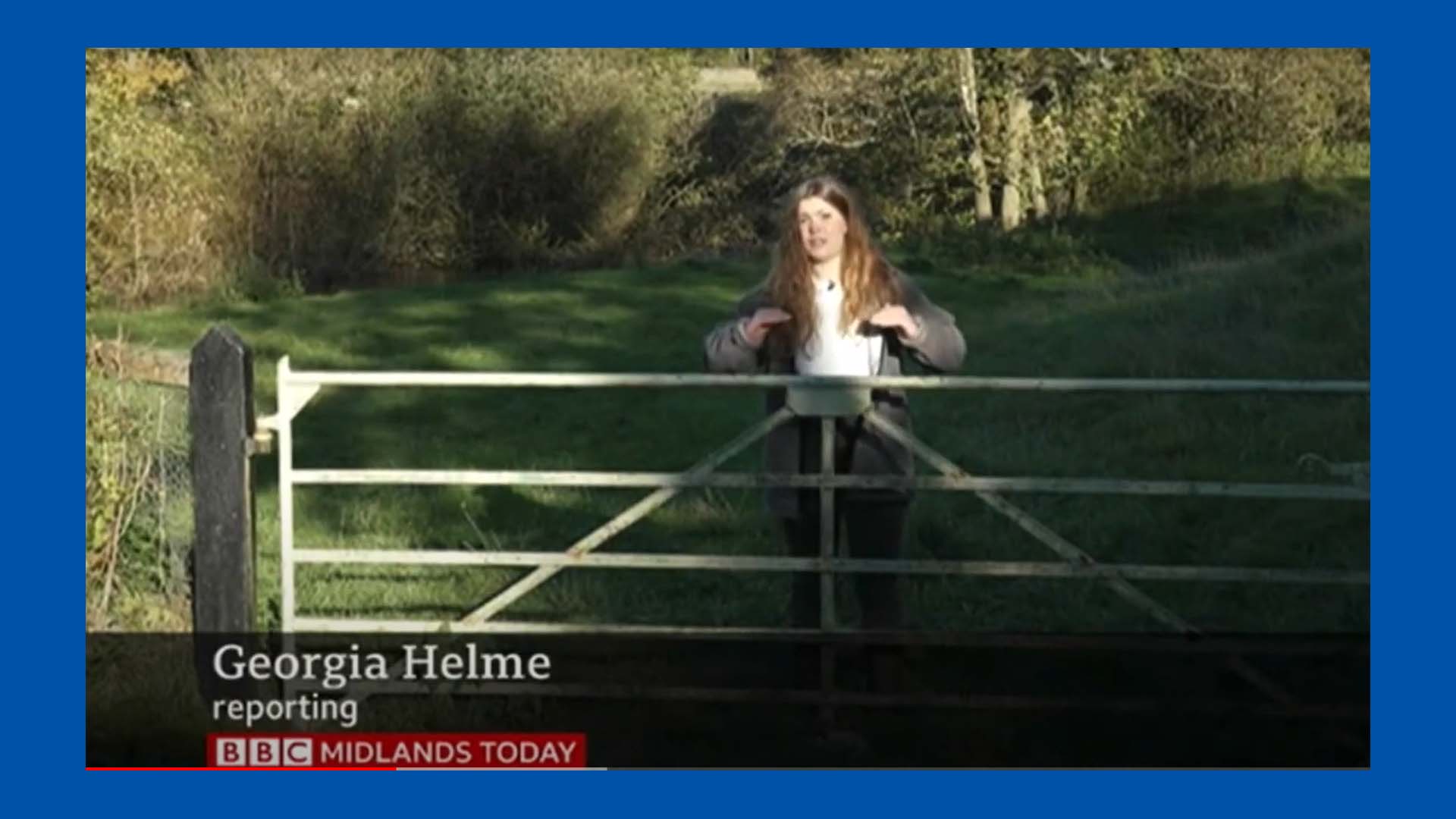 Georgia Helme stood by a gate demonstrating how high the water rose in 2020