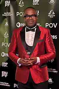 Obi Emelonye standing with an award