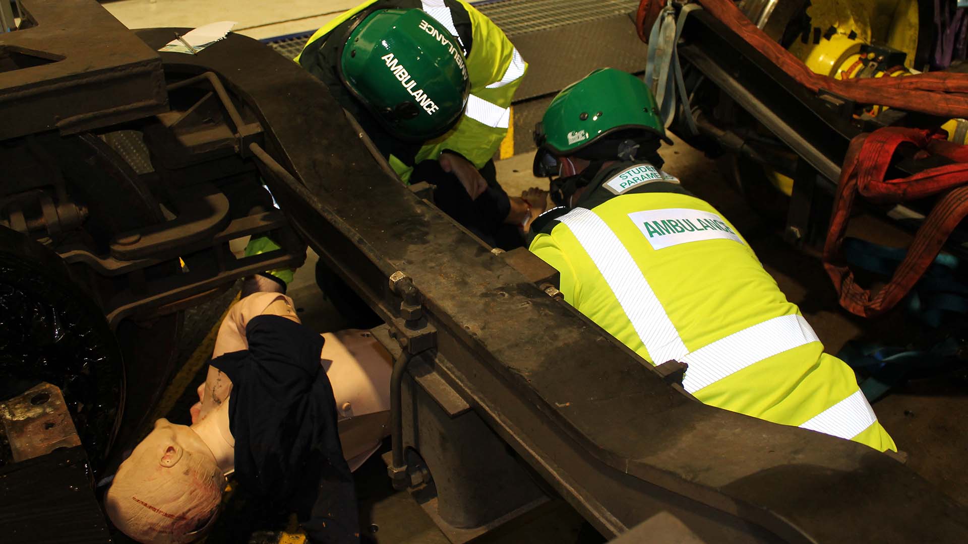 Two student paramedics with a mannequin