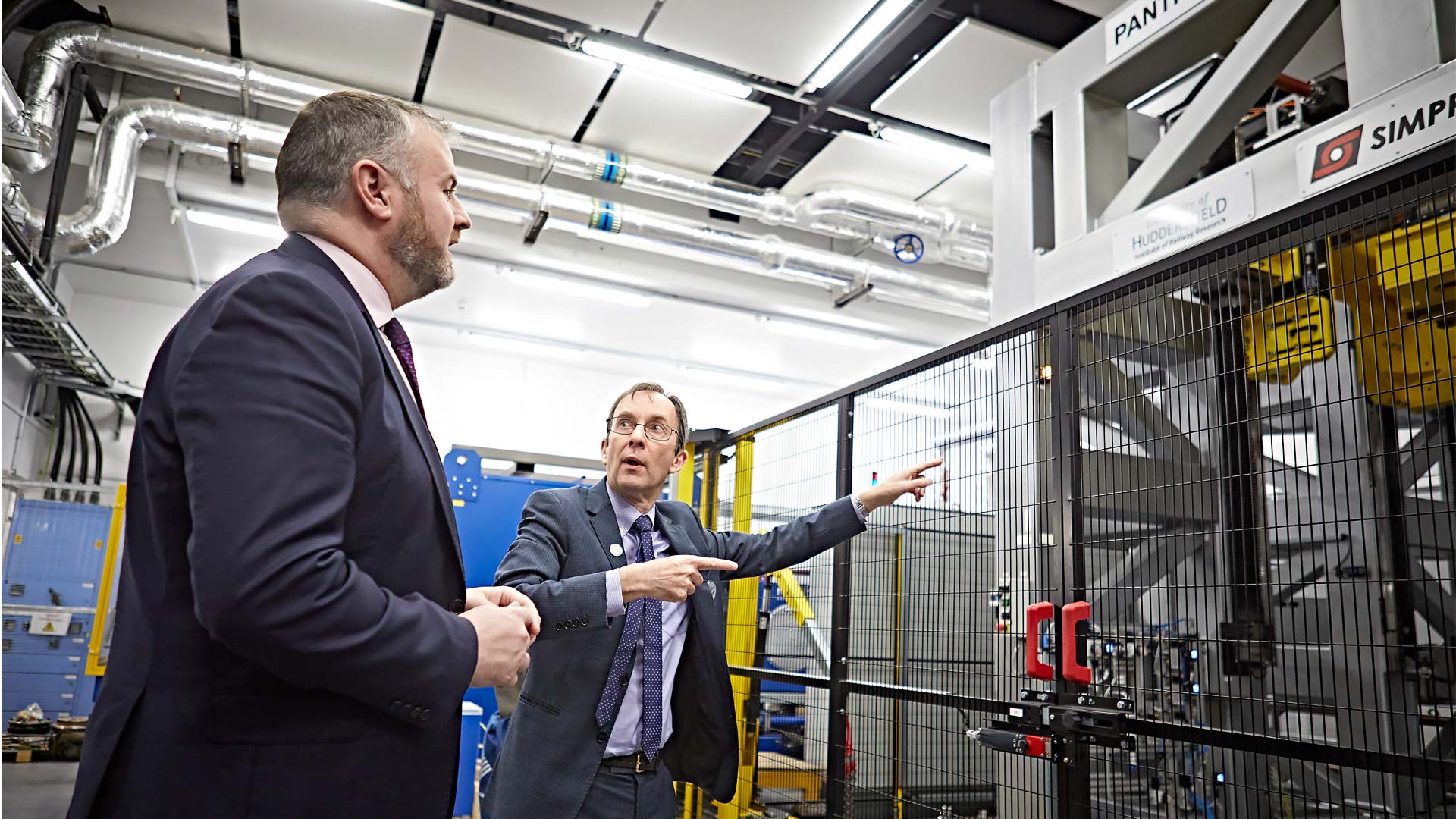 Professor Simon Iwnicki with Andrew Stephenson MP talking about the High Speed Pantograph Testing Rig