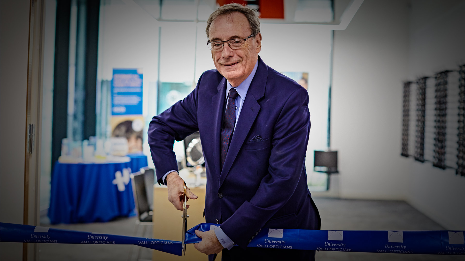 The University's Chancellor Sir George Buckley cut the ribbon before announcing University Valli Opticians officially 'open for business'