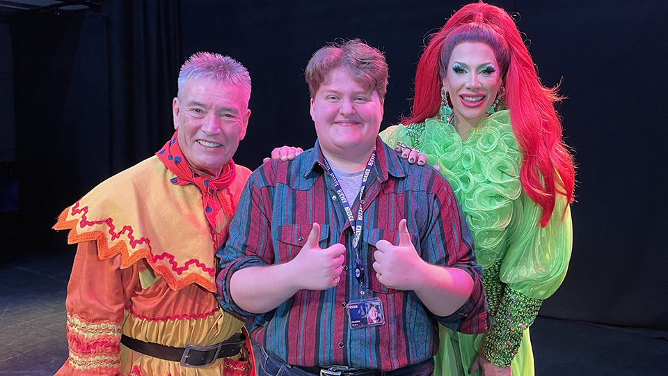 Fletcher Shore with two actors on stage at a pantomime rehearsal