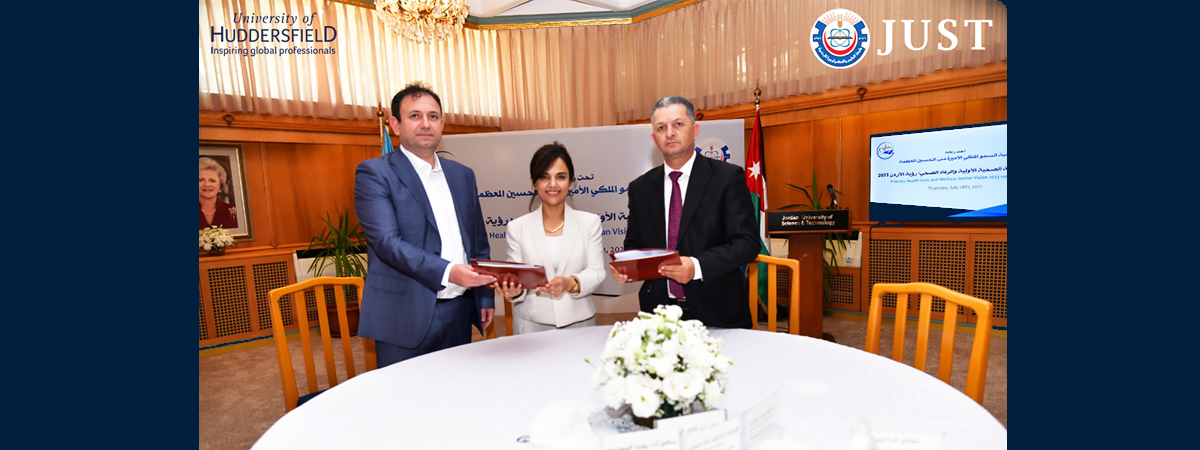 Group of three officials attend the ceremony to mark the signing of the agreement