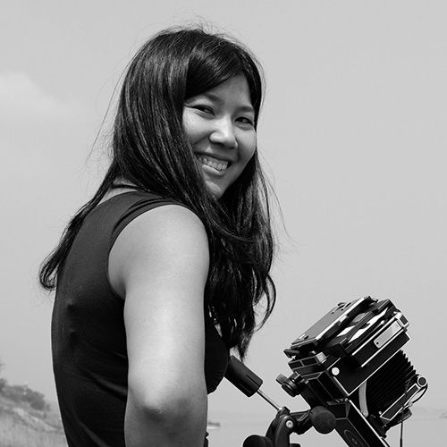 Yan Preston smiling with a camera