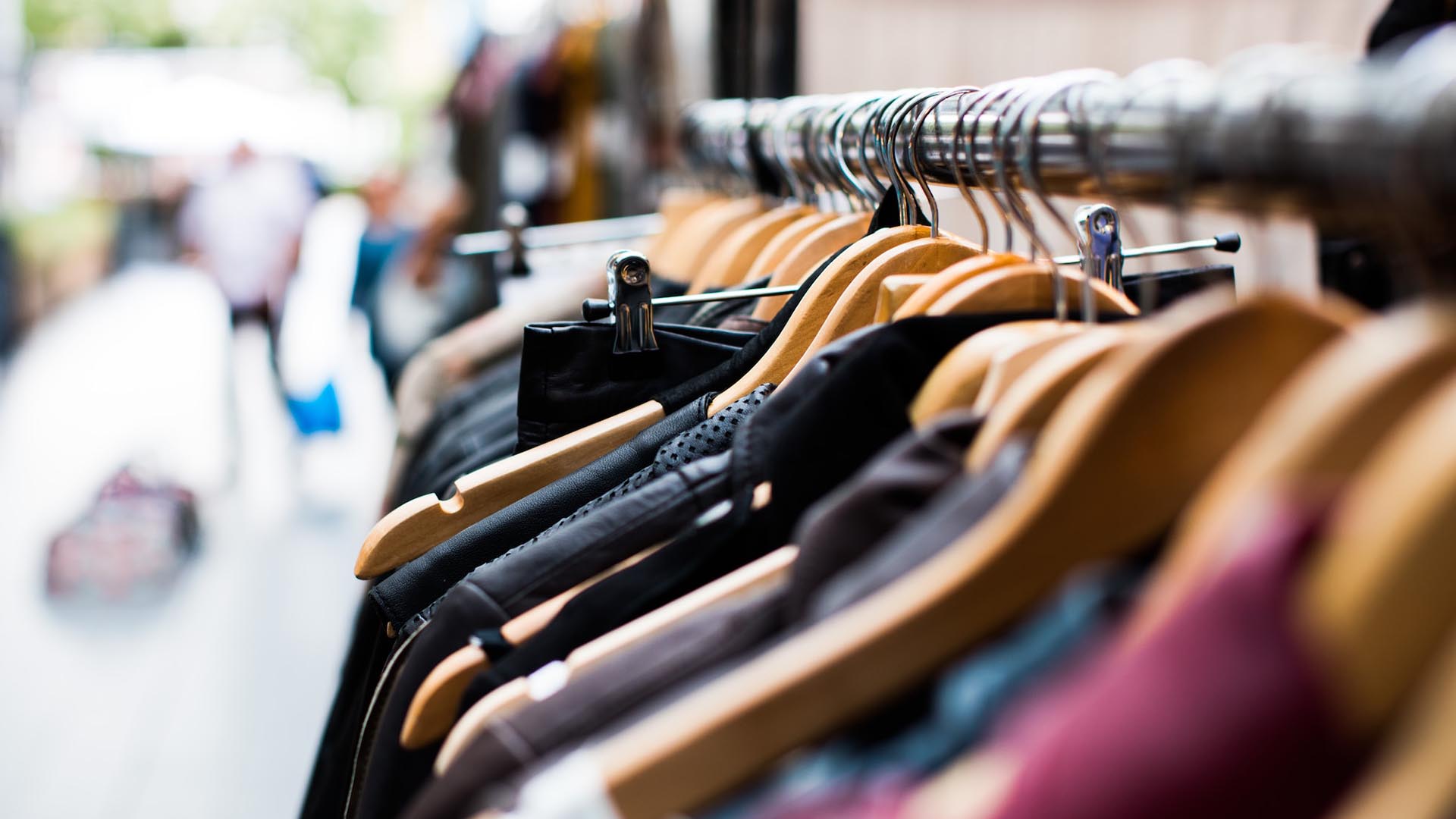 Clothes on coat hangers hanging on a rail