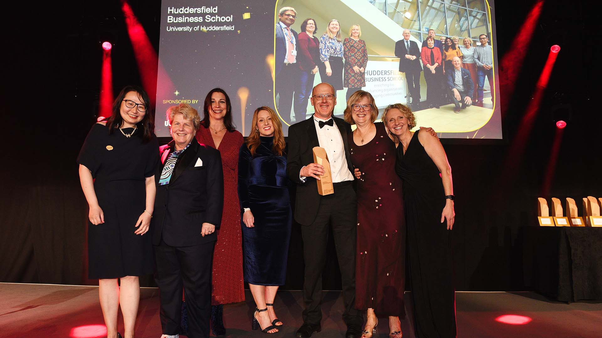 Business school staff stand with their trophy at the Times Higher Education Awards
