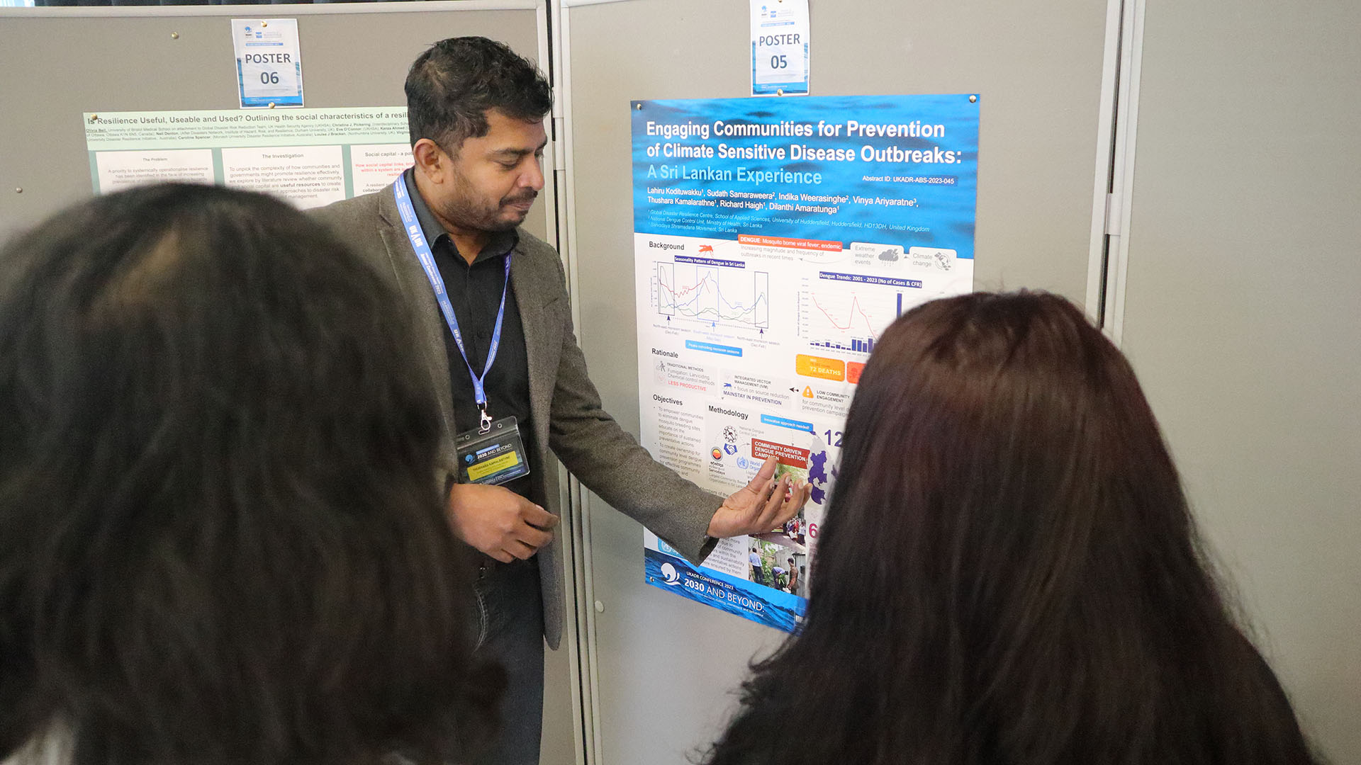 People being shown a poster with facts at a conference in Huddersfield