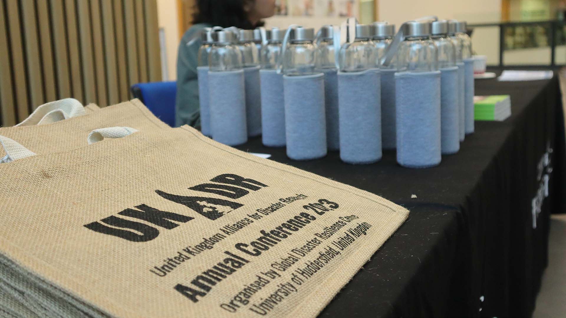 Bottles arranged on a table with a bag