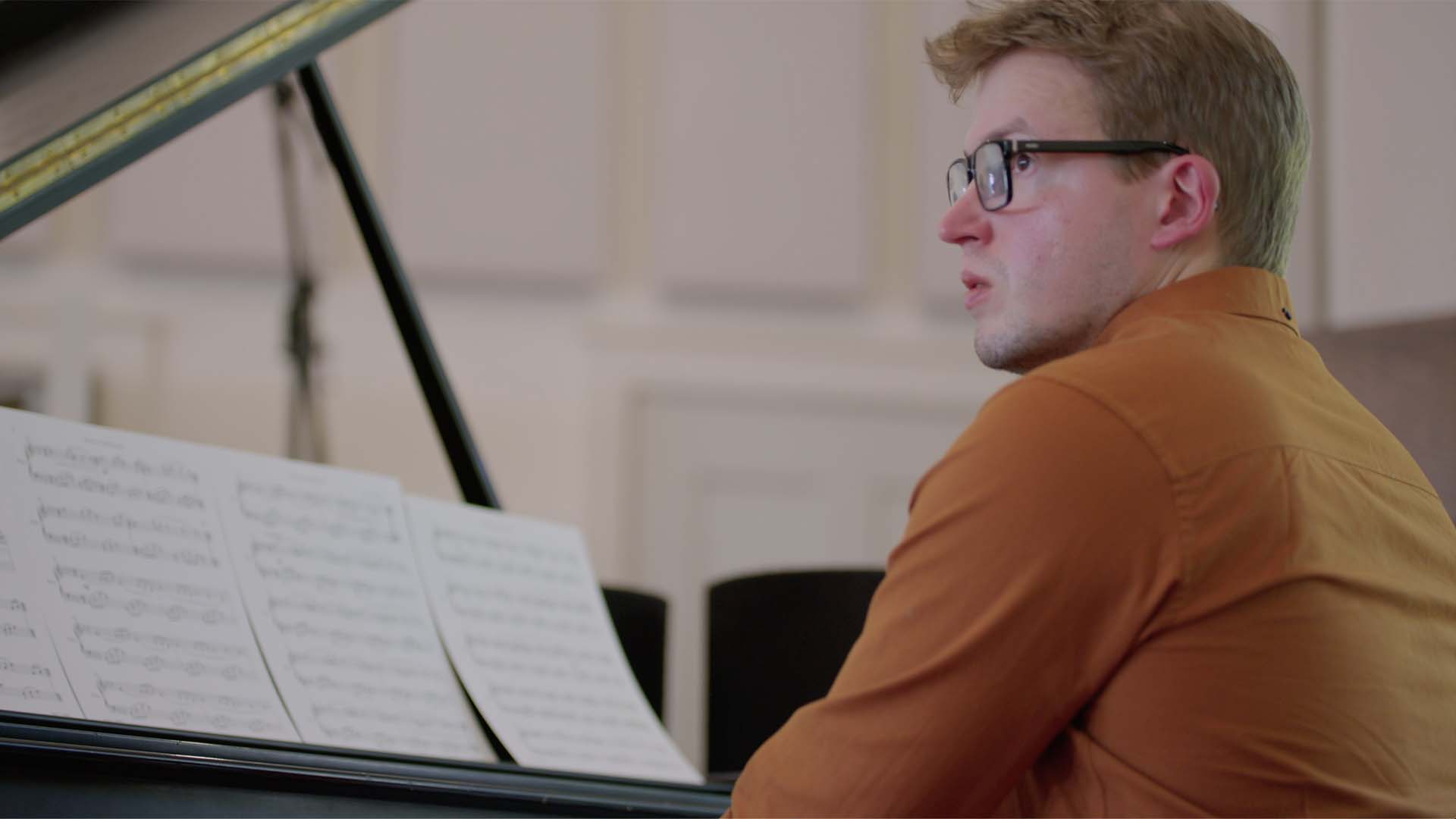 Stephen Gott sat at a piano