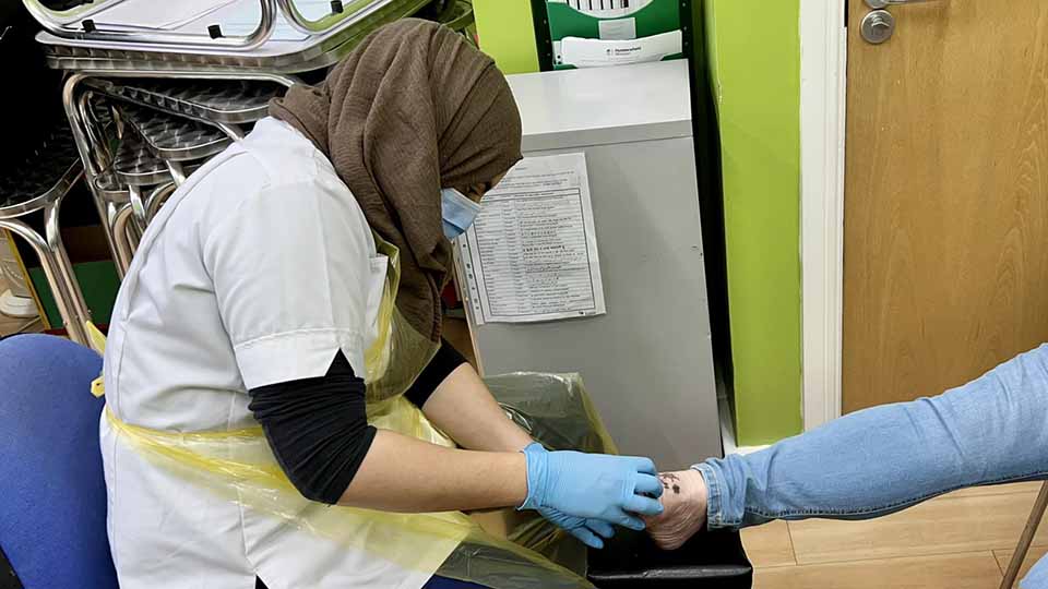 A podiatrist works on a foot