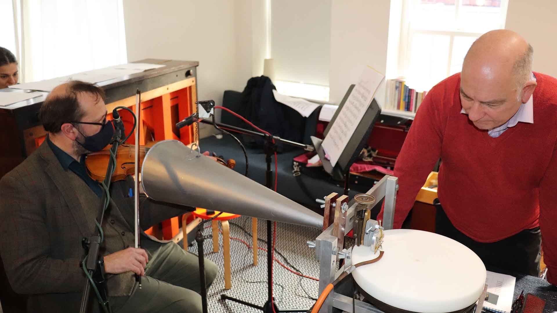 Musicians using old recording technology in a studio