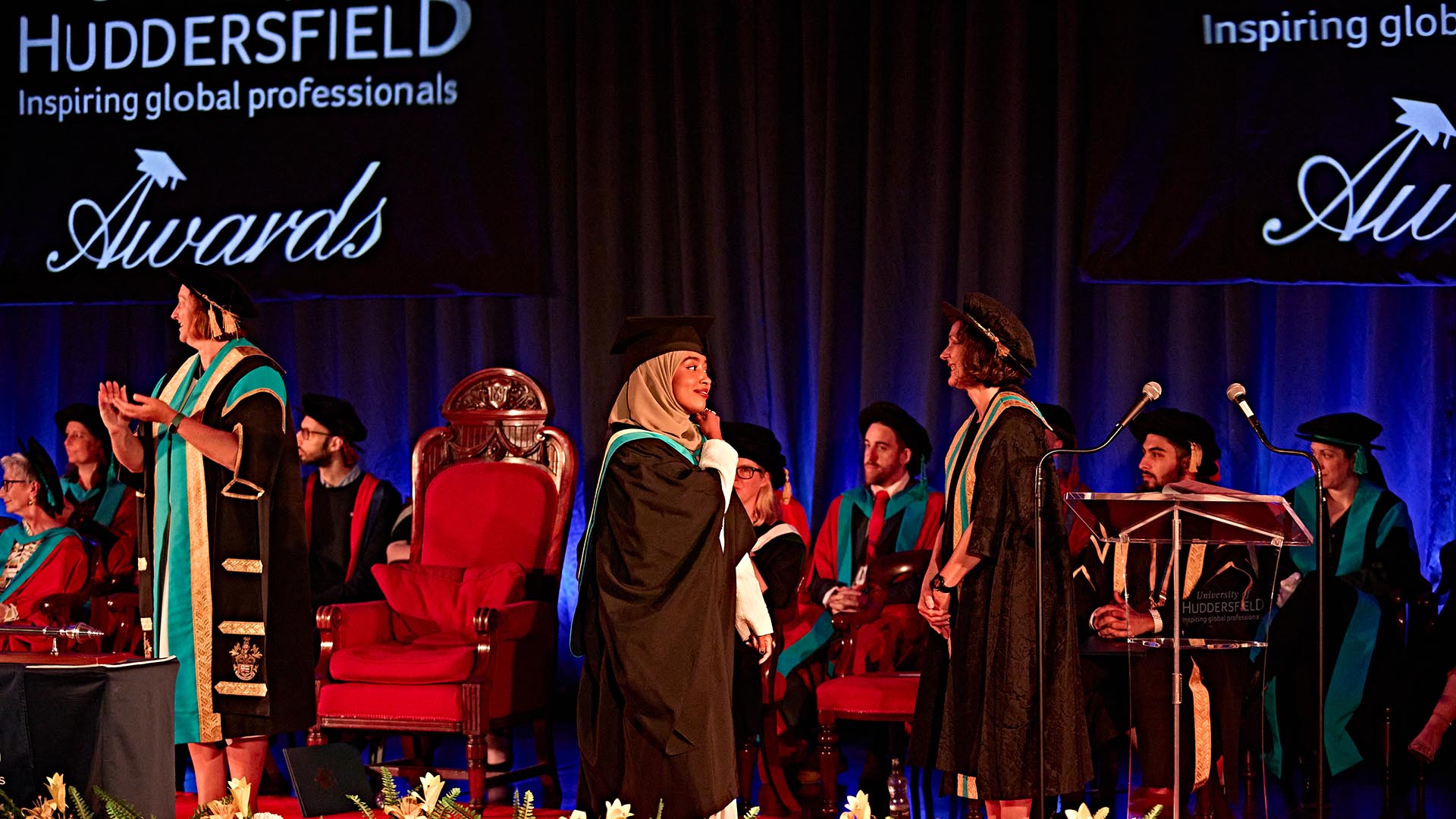 A happy student accepts her degree