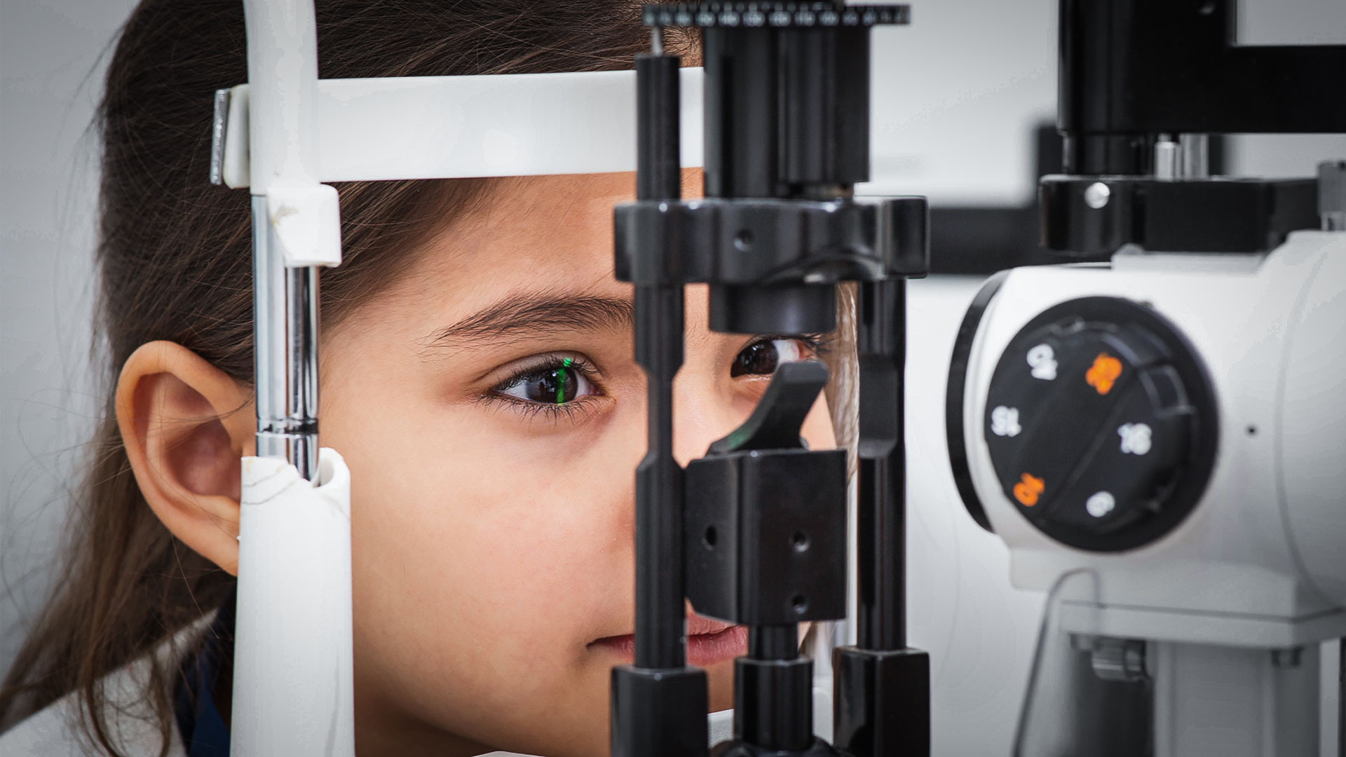 Young girl having her eyes examined