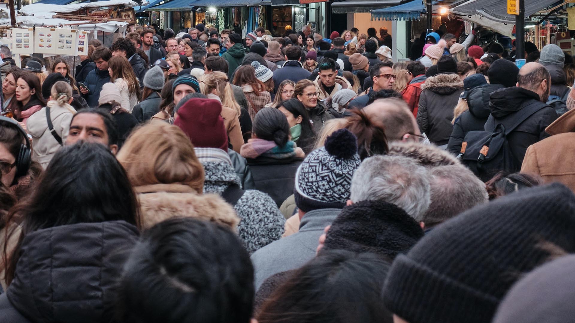People walking along a busy street in that there trendy London
