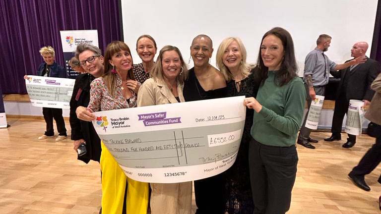 Rachel Armitage and a cheque for charity for Talking Forward with mayor Tracey Brabin