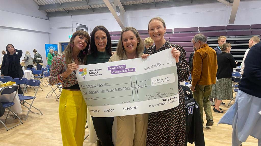 Rachel Armitage and a cheque for charity for Talking Forward