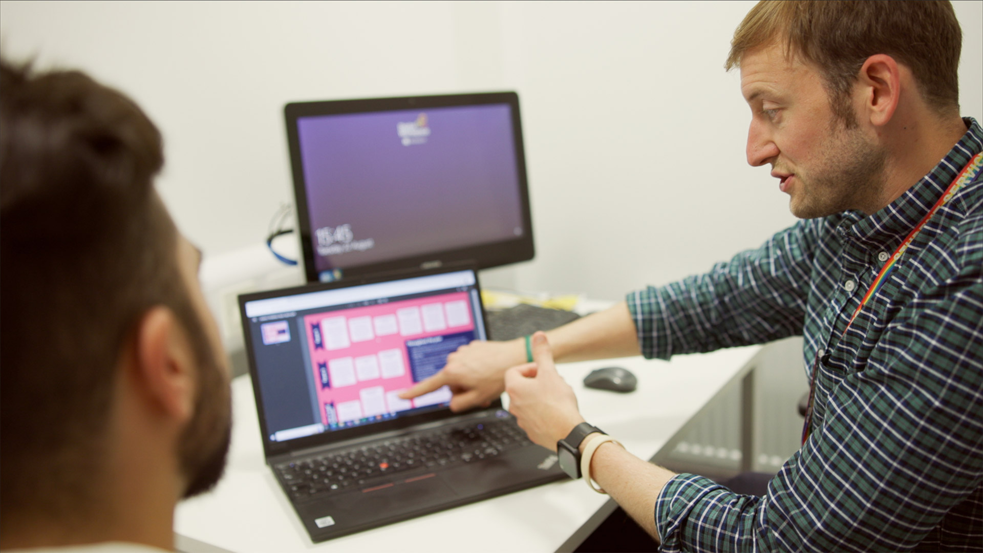 A tutor and student at a laptop
