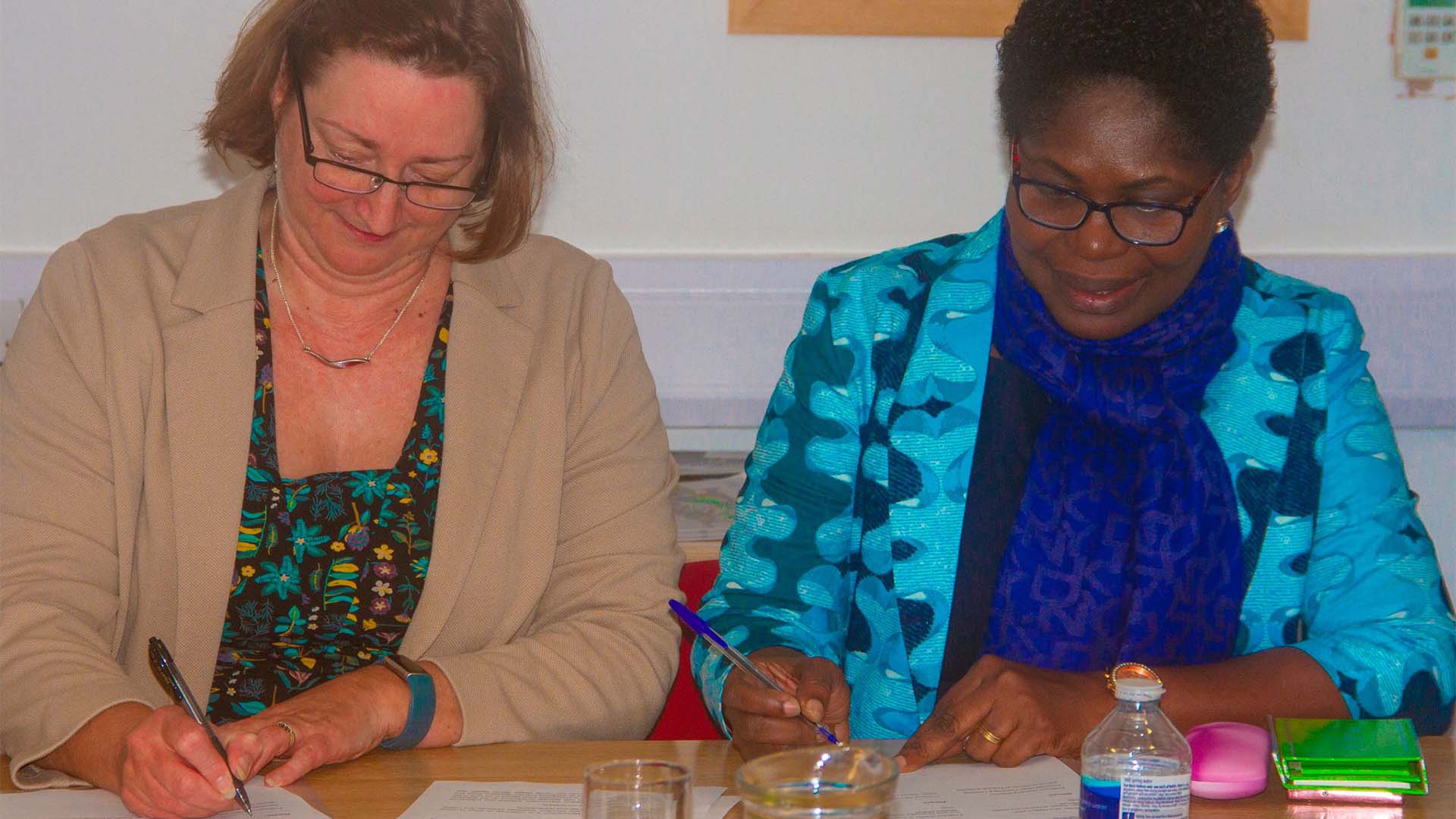 Professor Jane Owen Lynch signs an MOU with Philomina Woolley