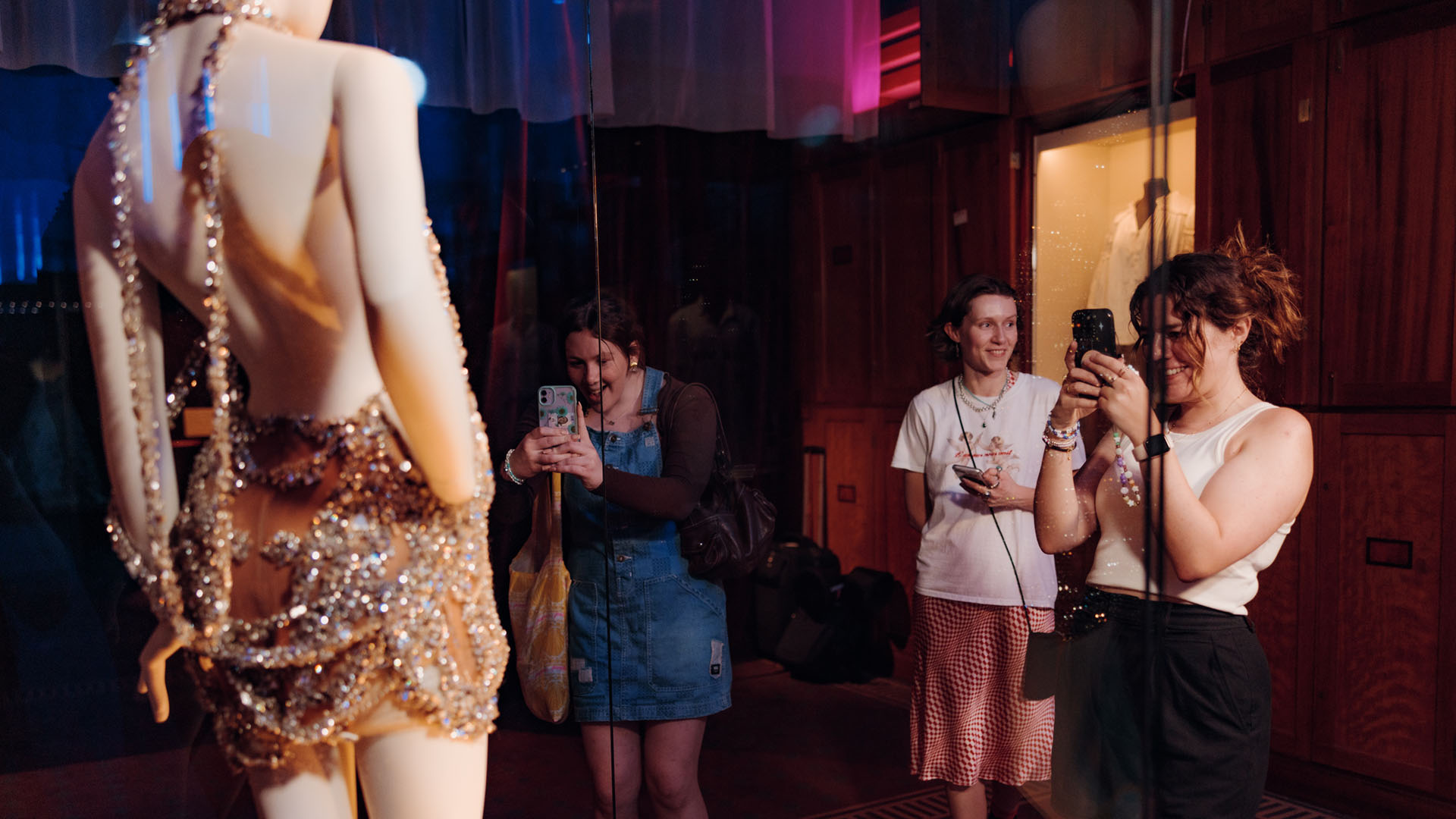 Taylor Swift fans look at a dress in the V and A