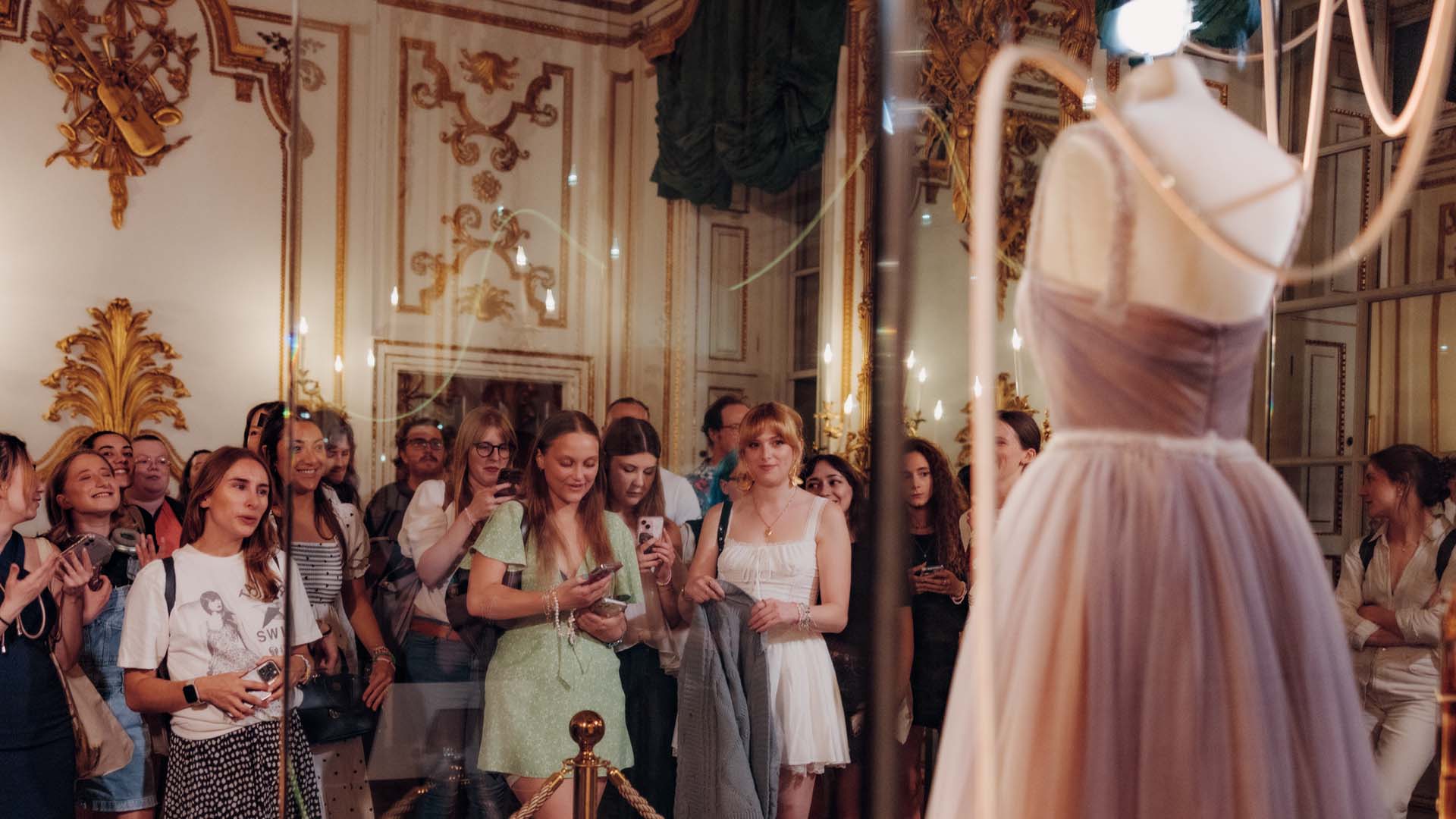 Taylor Swift fans look at a dress in the V and A