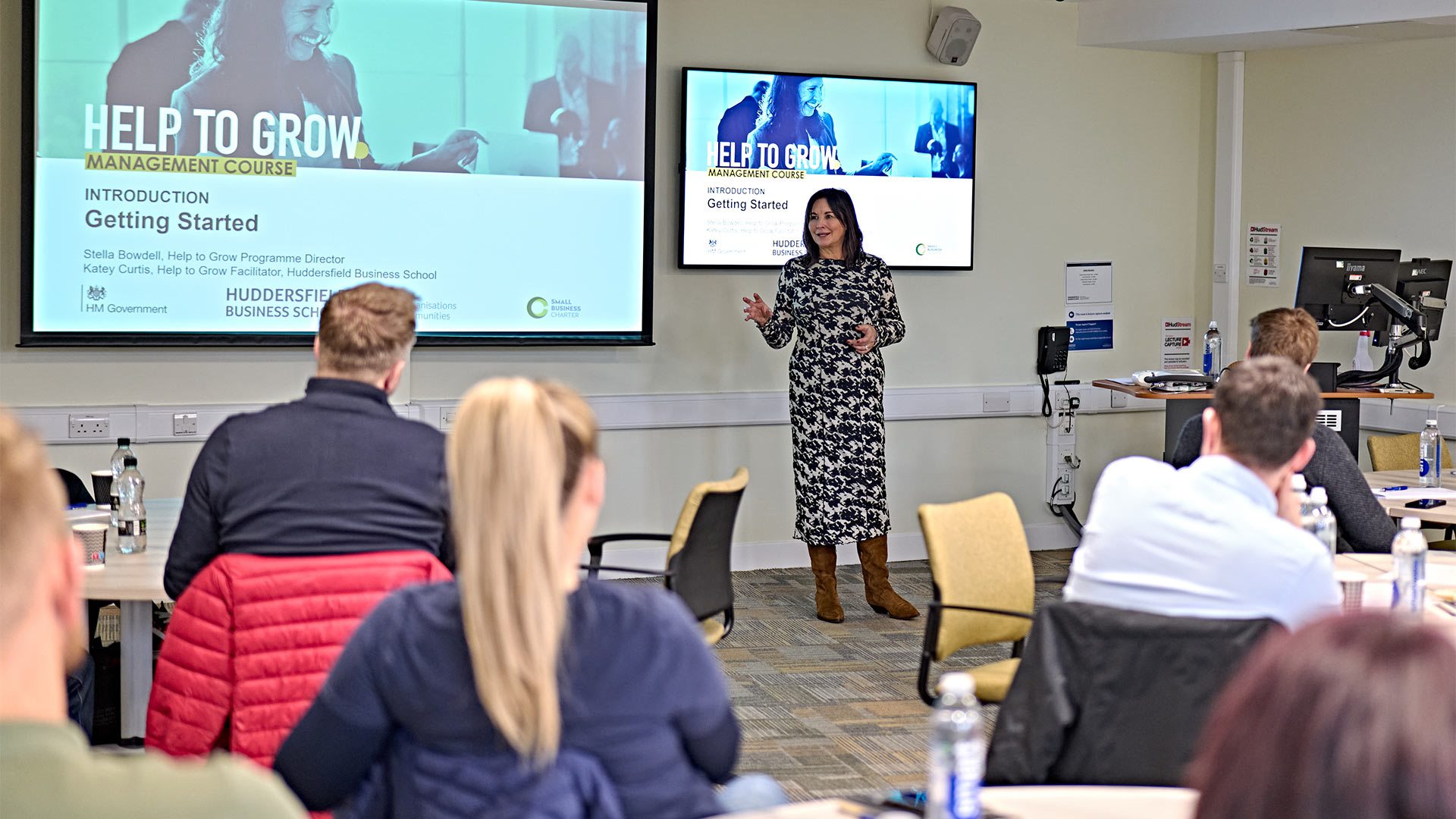 A woman presenting in front of a group of people