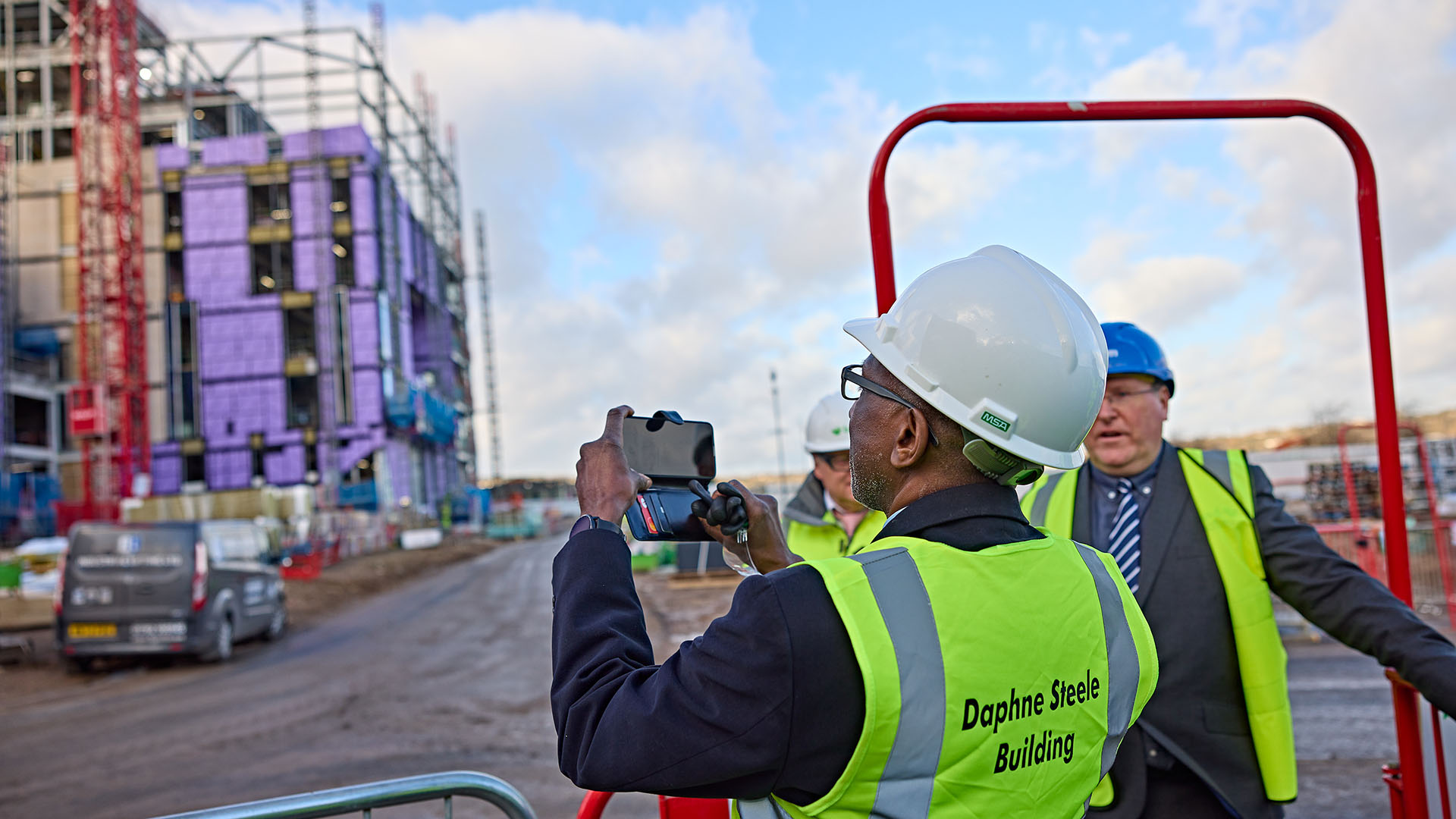 Robert Steele takes a photo of the new building