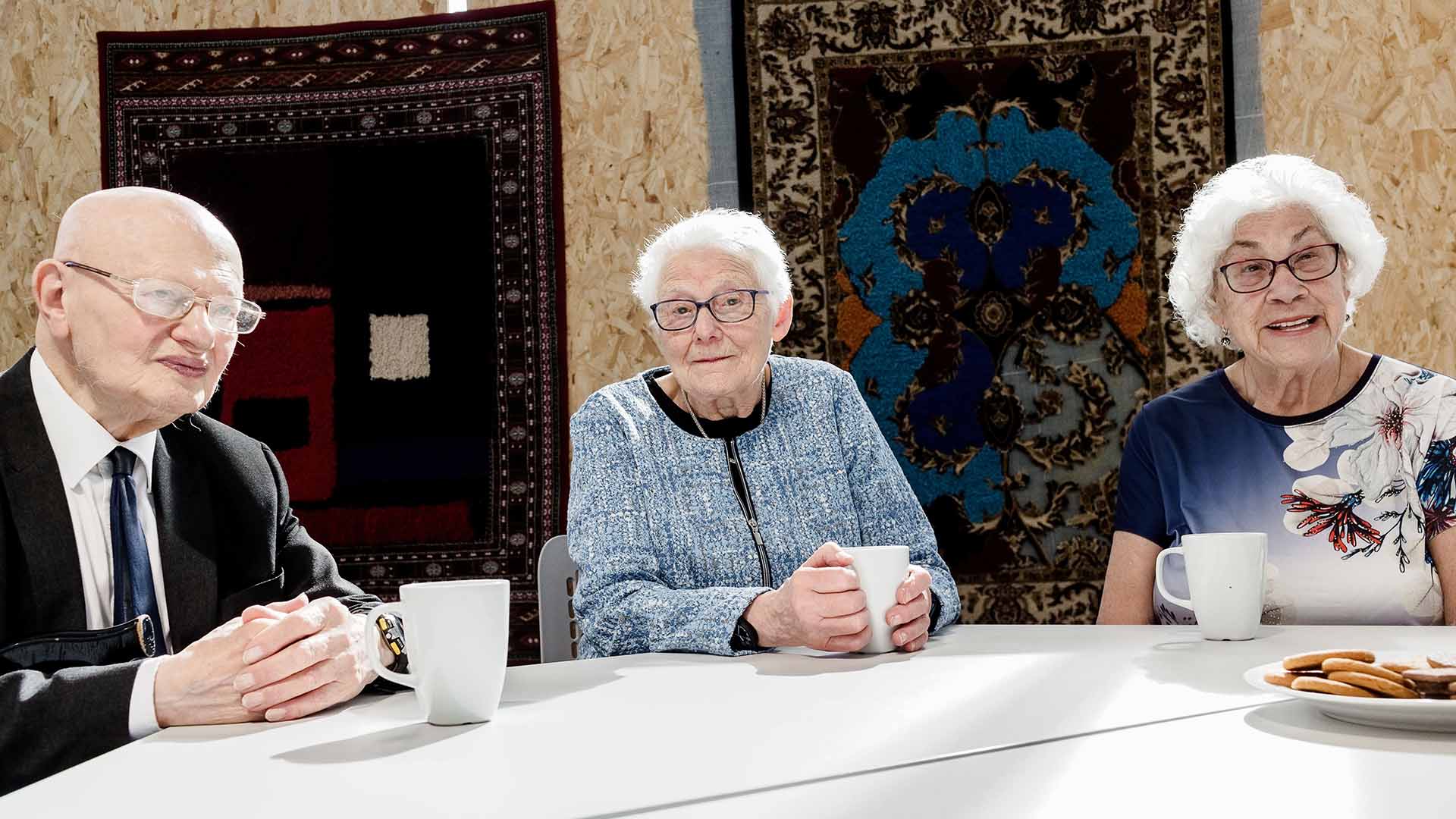 Three Holocaust survivors drinking tea at the Holocaust Centre North