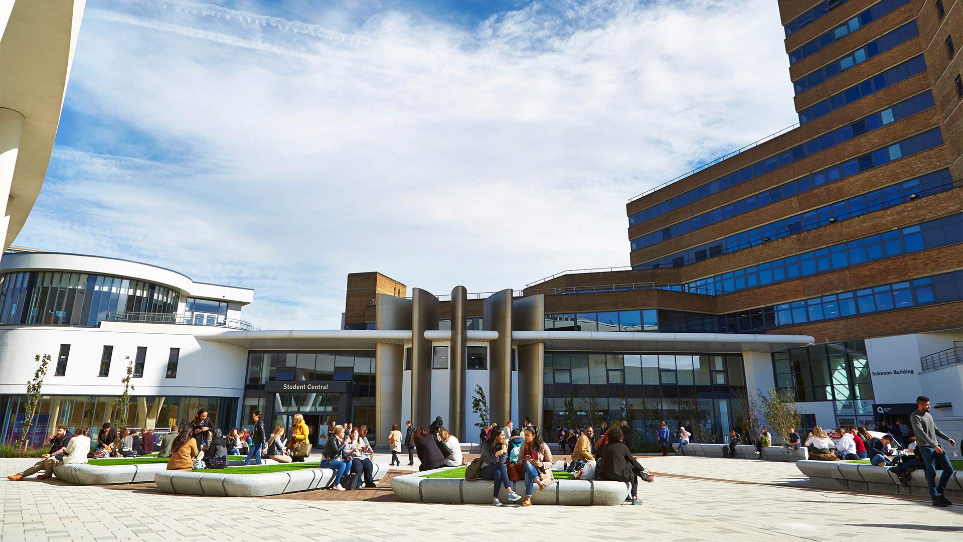Students sitting outside in University Square at Huddersfield