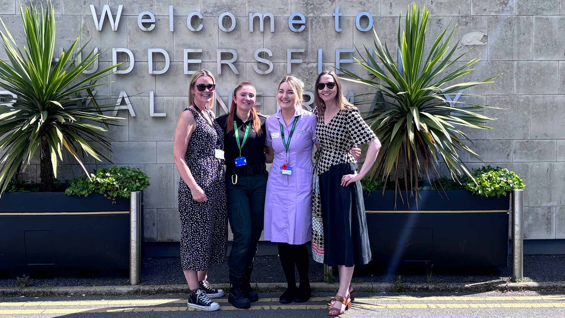 Paramedic students and staff outside Huddersfield hospital sign