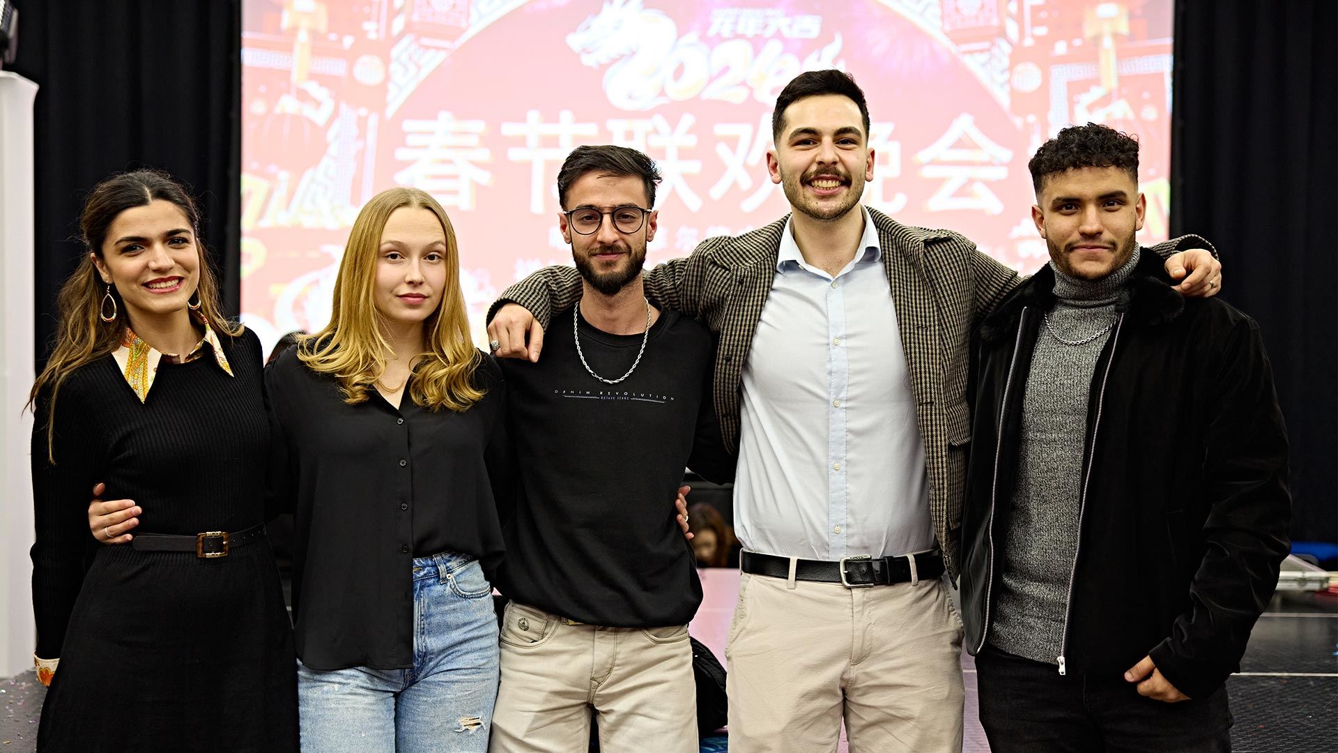 A group of students with their arms around each other