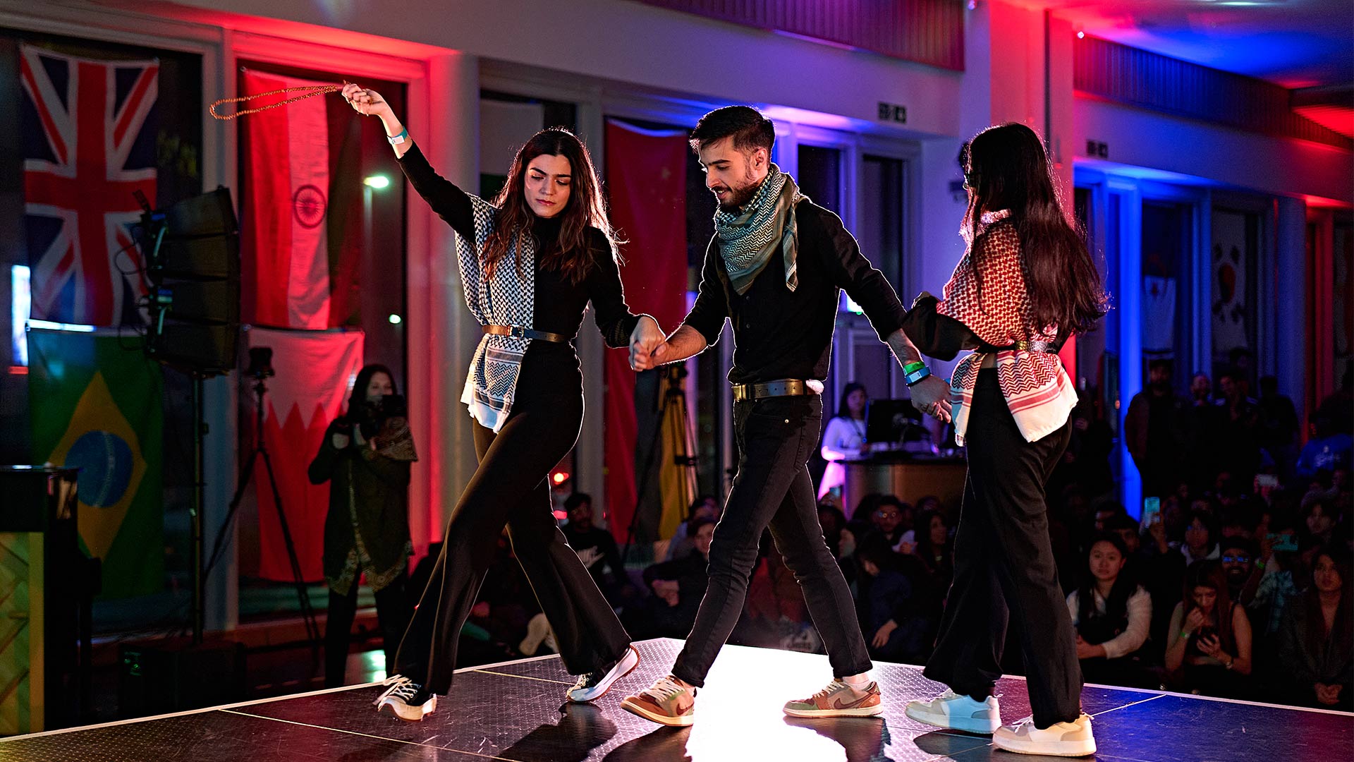 three people dancing on stage