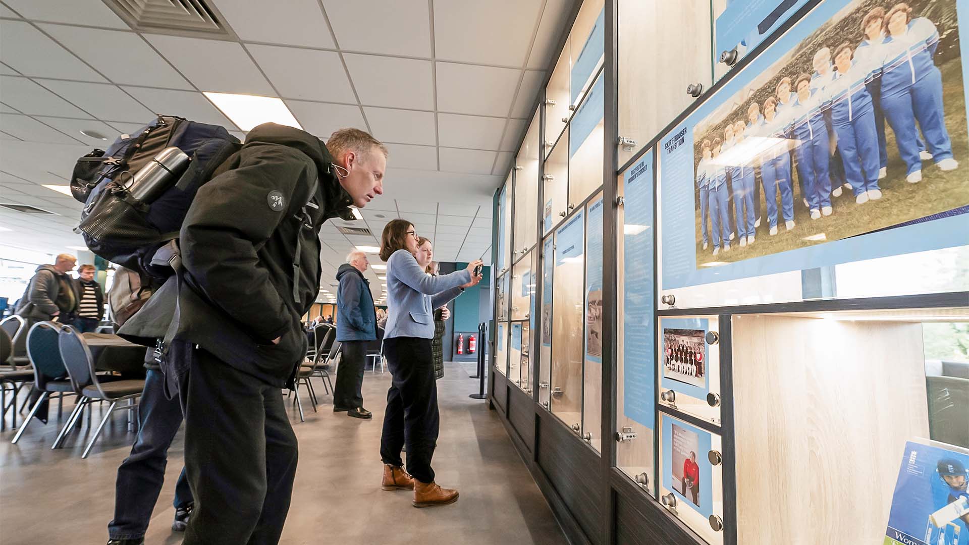 People look into the exhibition cabinet on women's cricket