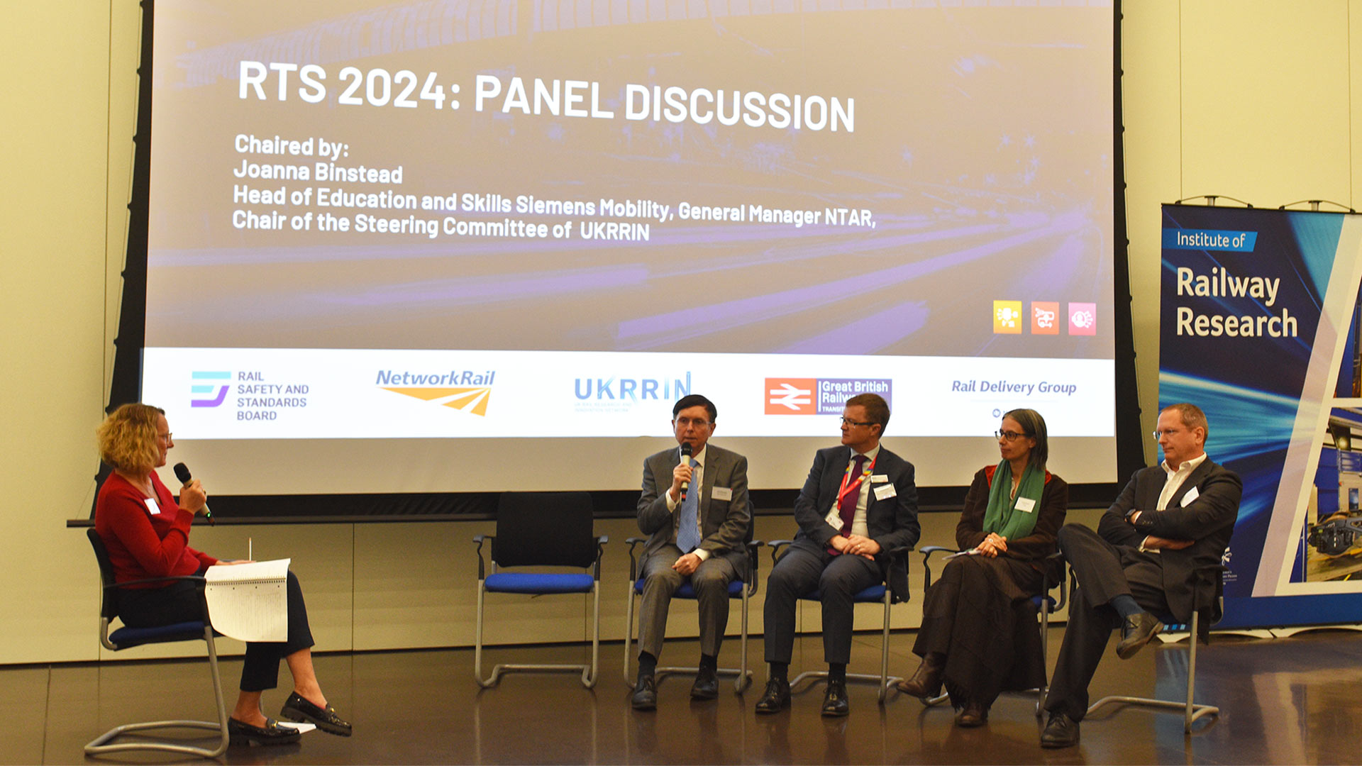 A group of people at a workshop event as part of a panel