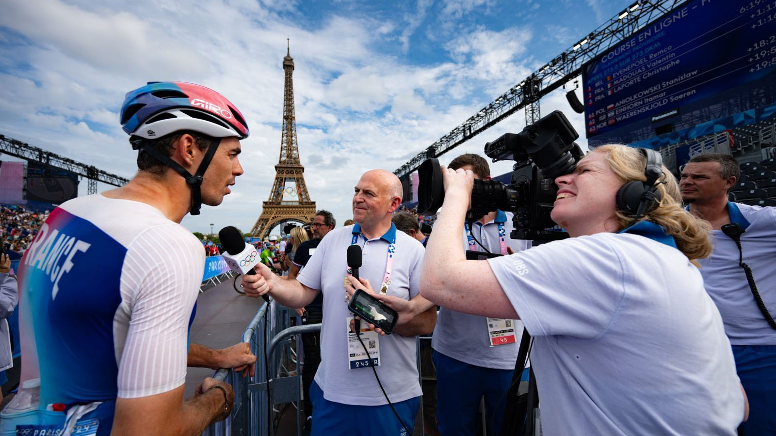 David Easson interviews a cyclist in front of the Eiffel Tower at the Paris Olympics