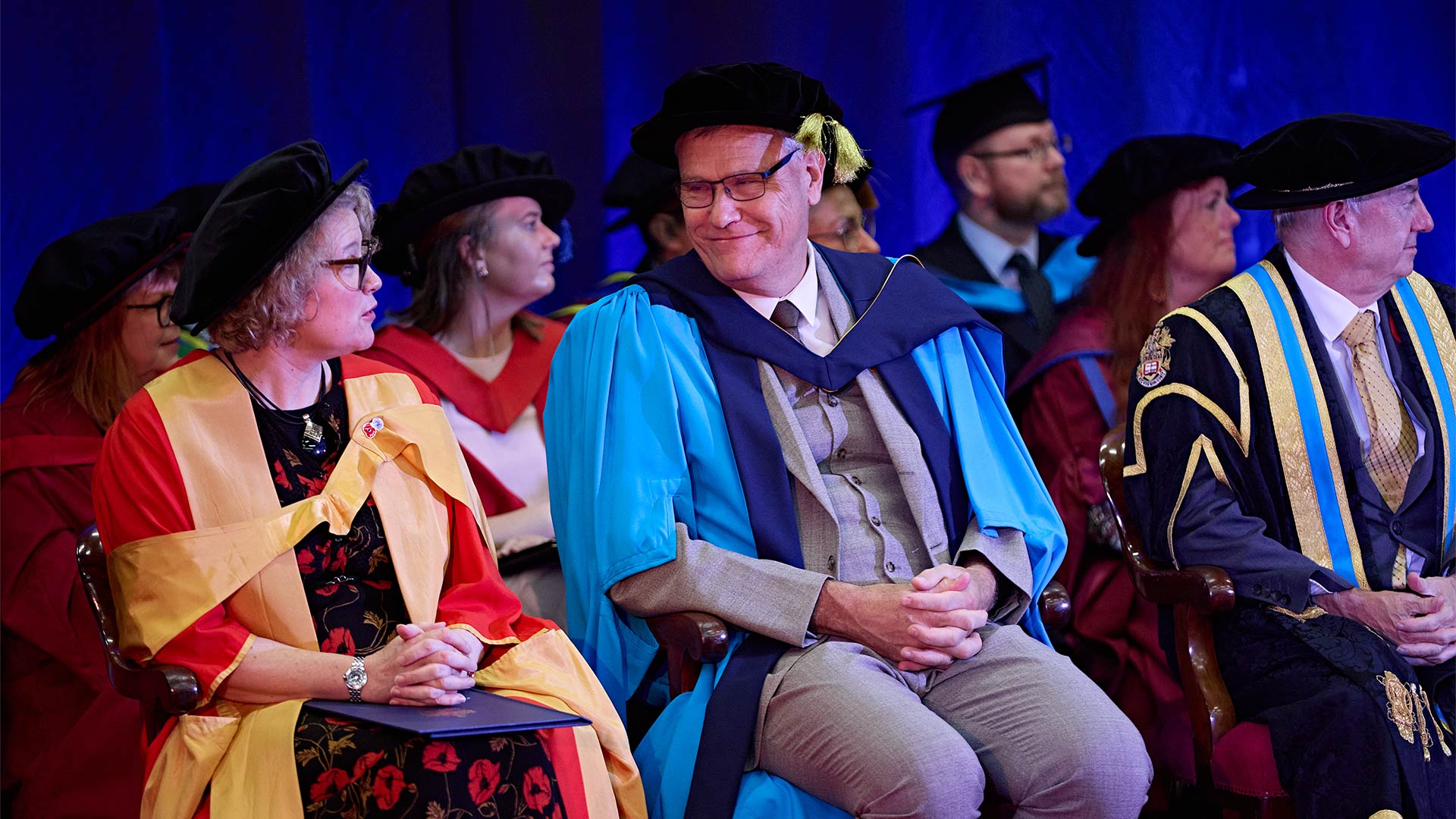 People on stage during a graduation ceremony