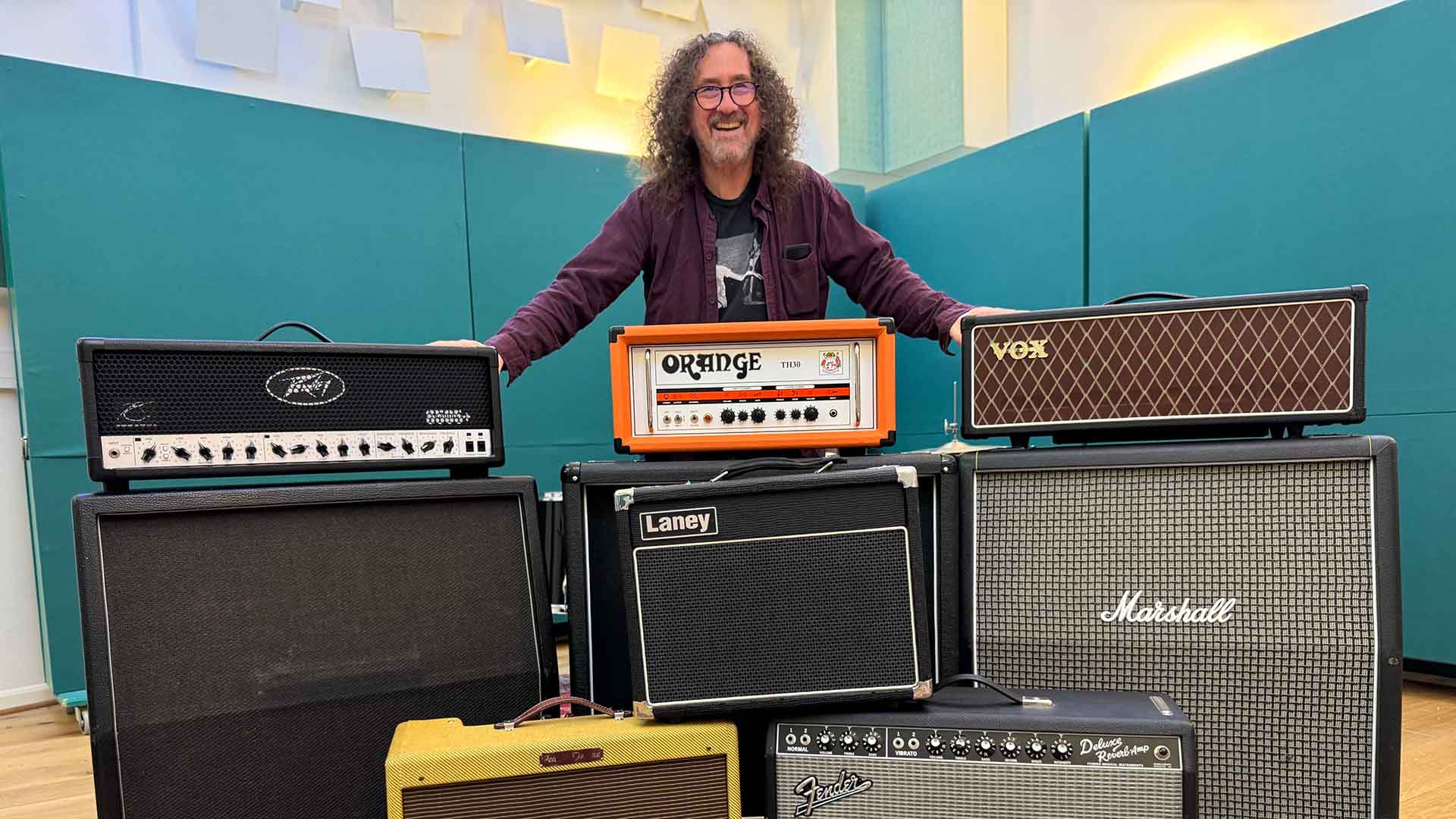 Professor Steve Waksman stands behind some amplifiers