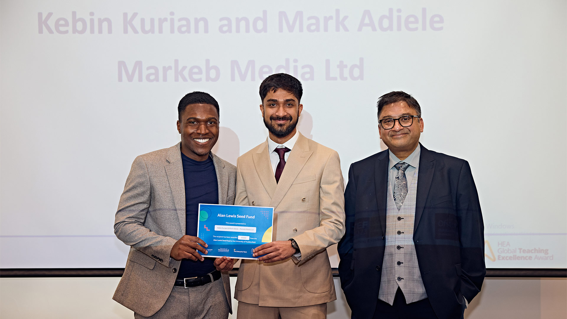 Two people being presented with an award
