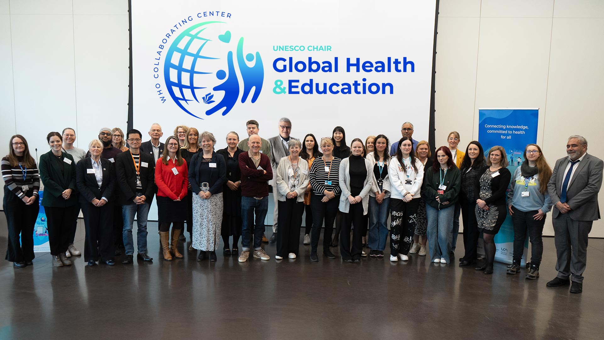 A group of people gathered at a UNESCO event at the University of Huddersfield