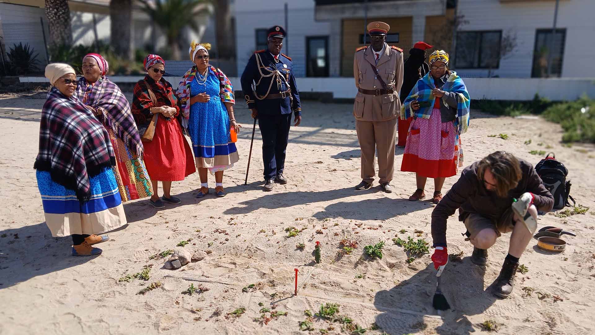 An archaeologist reveals a grave in Namibia with some local tribespeople
