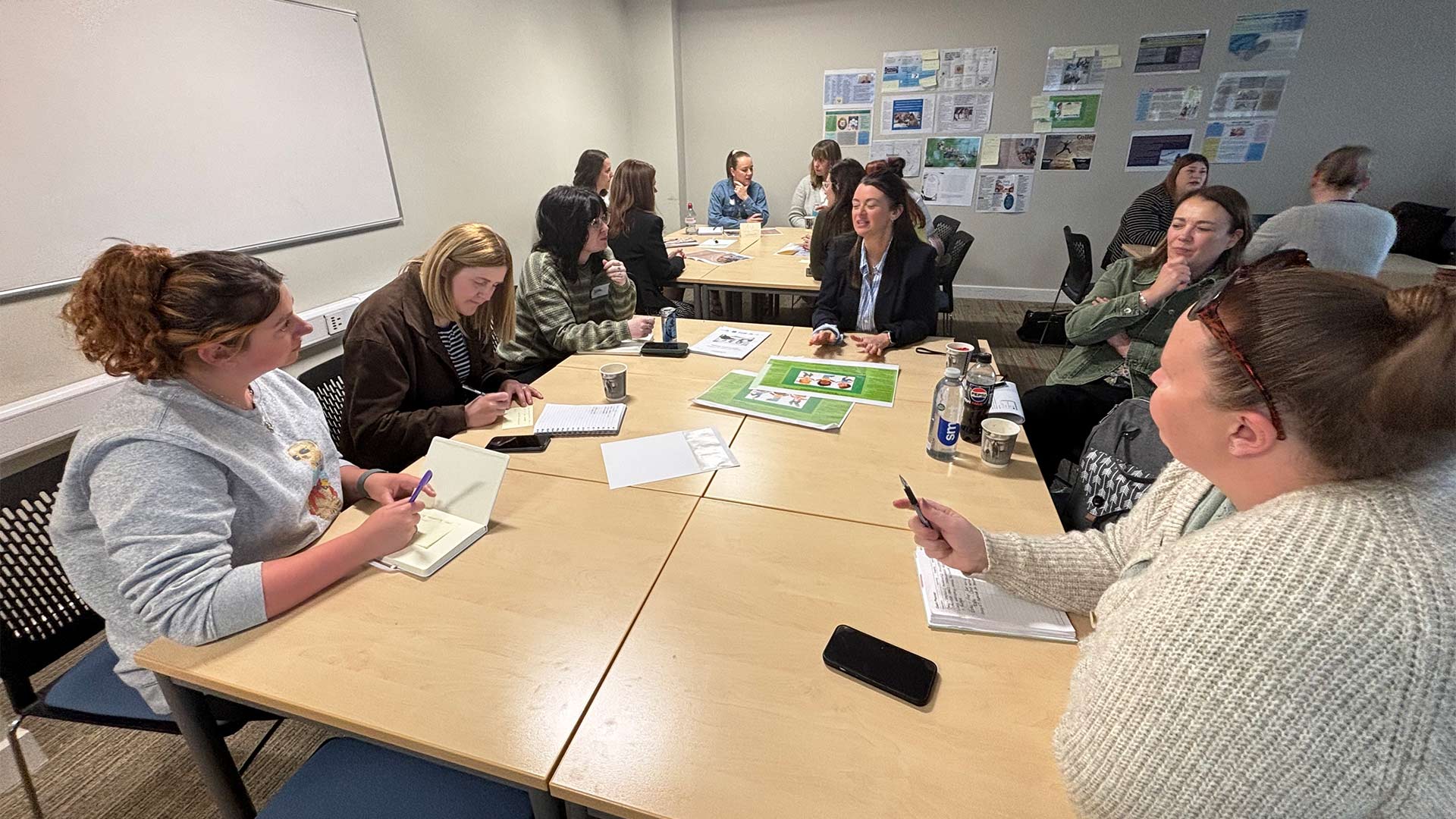 A group of people around a table at a conference