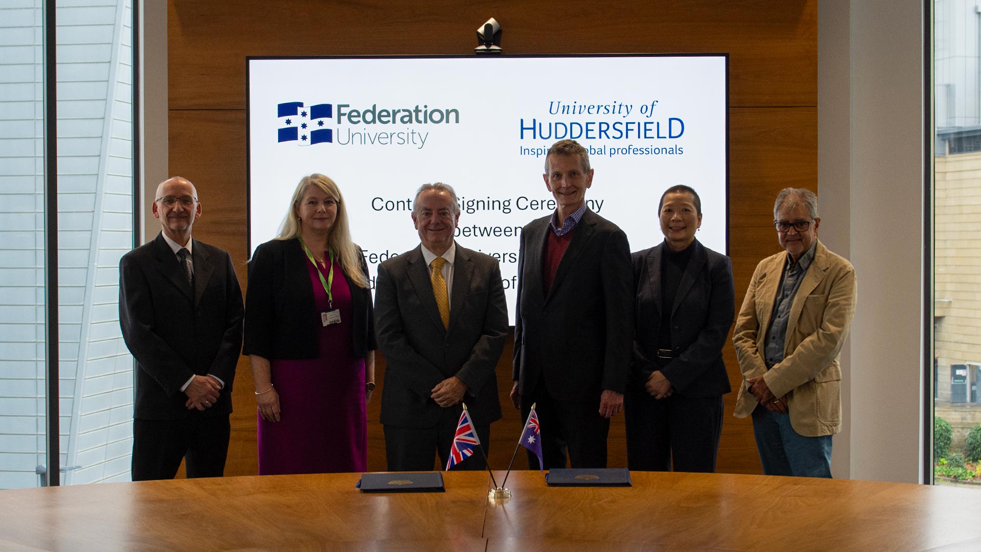 A group of people standing in a board room
