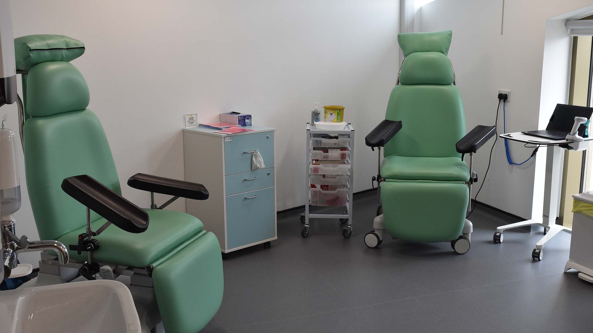 A medical suite with chairs and equipment