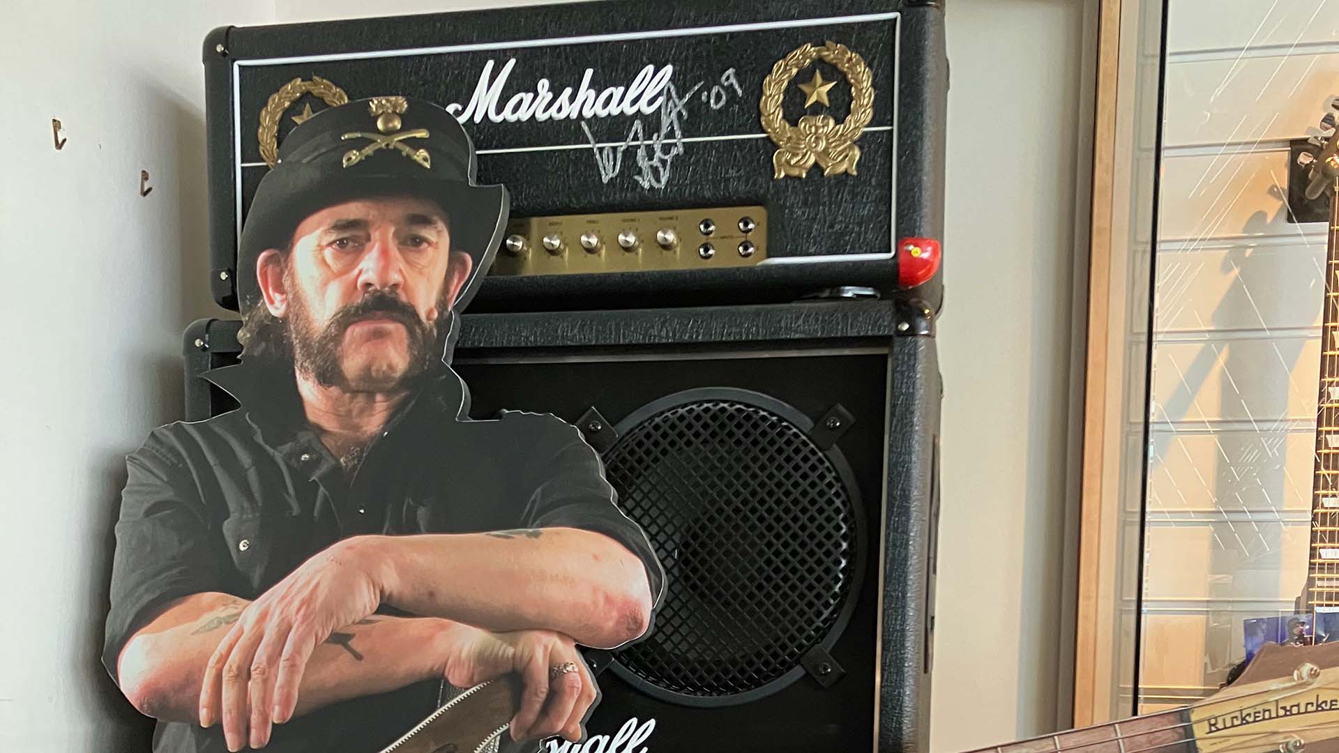 A cardboard cut out of Lemmy in front of a Marshall amp