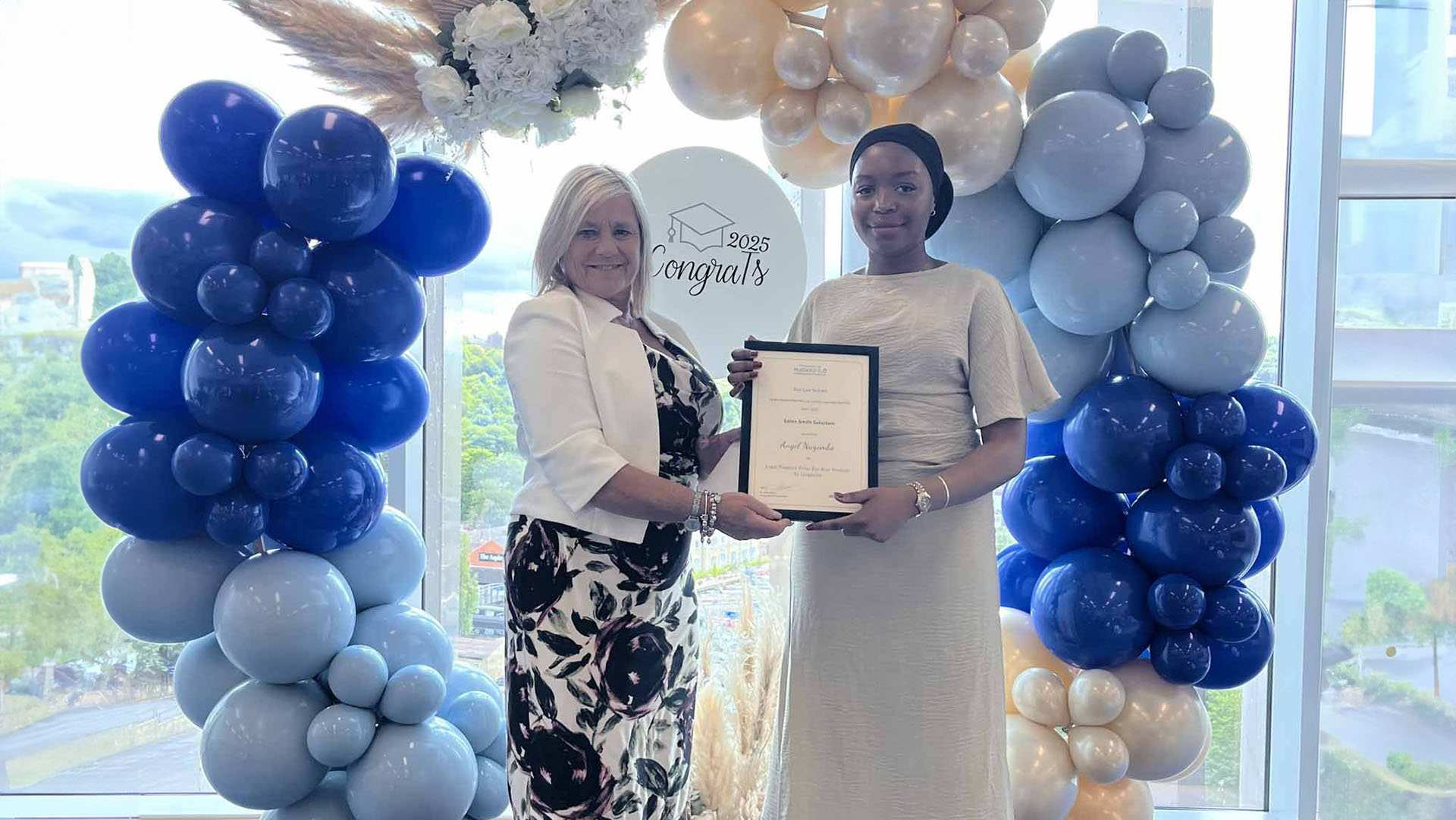 angel nagombo receiving a law award