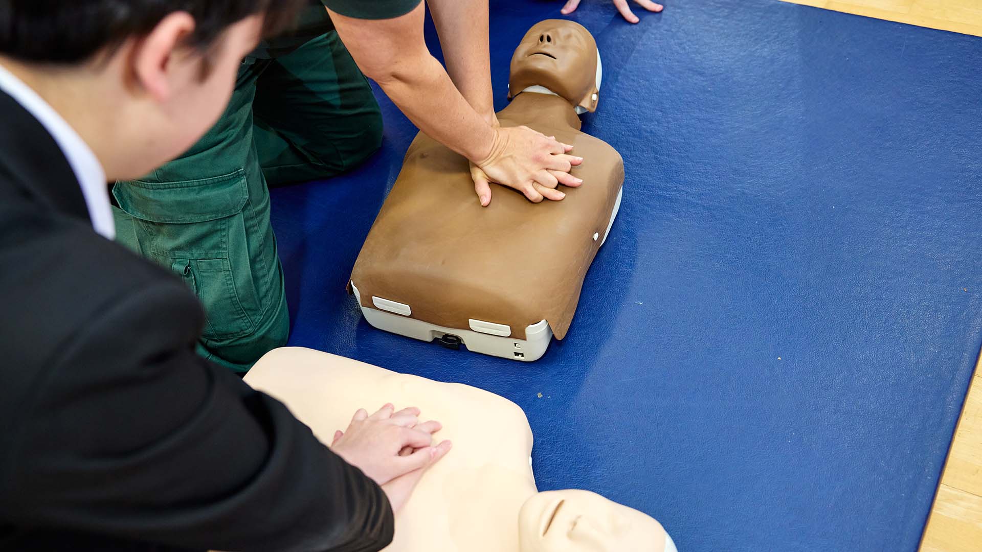 A school pupil performs CPR on a dummy