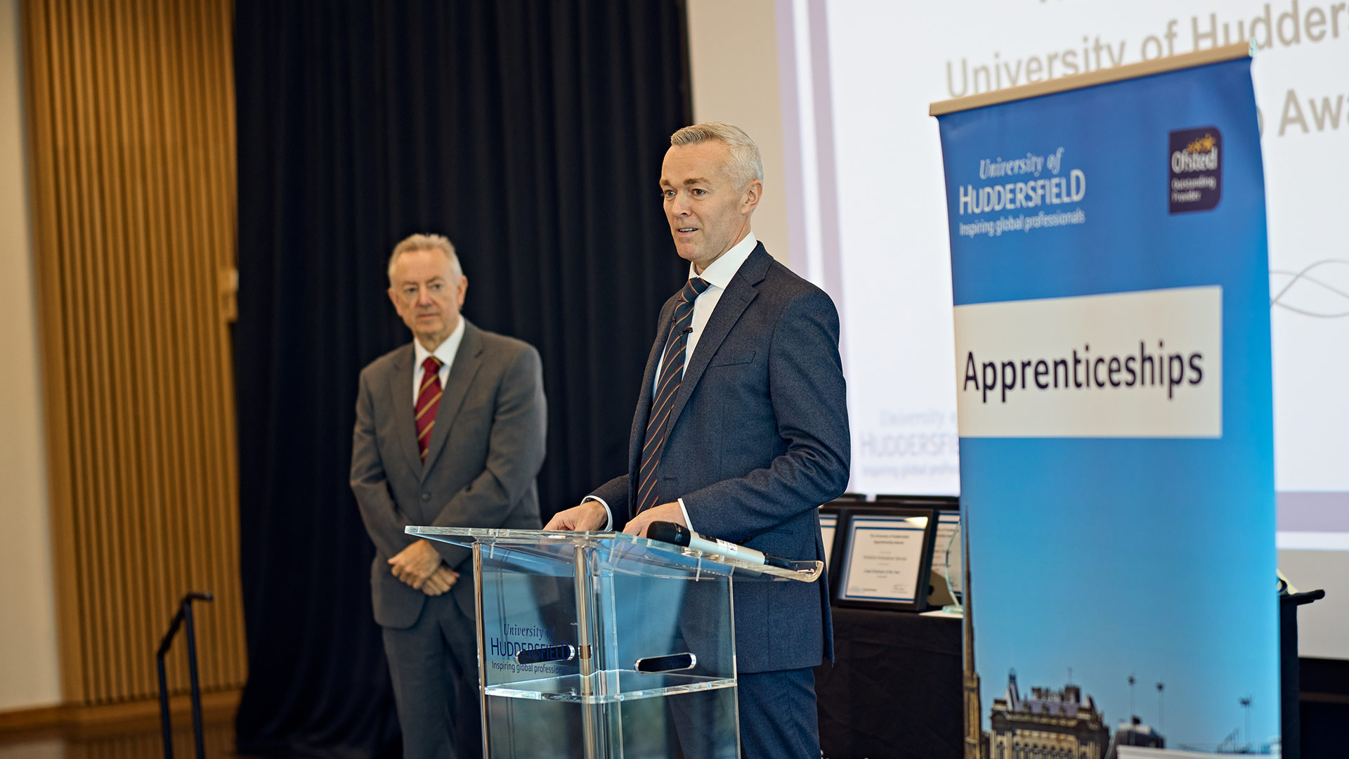 Two men on stage at an awards ceremony