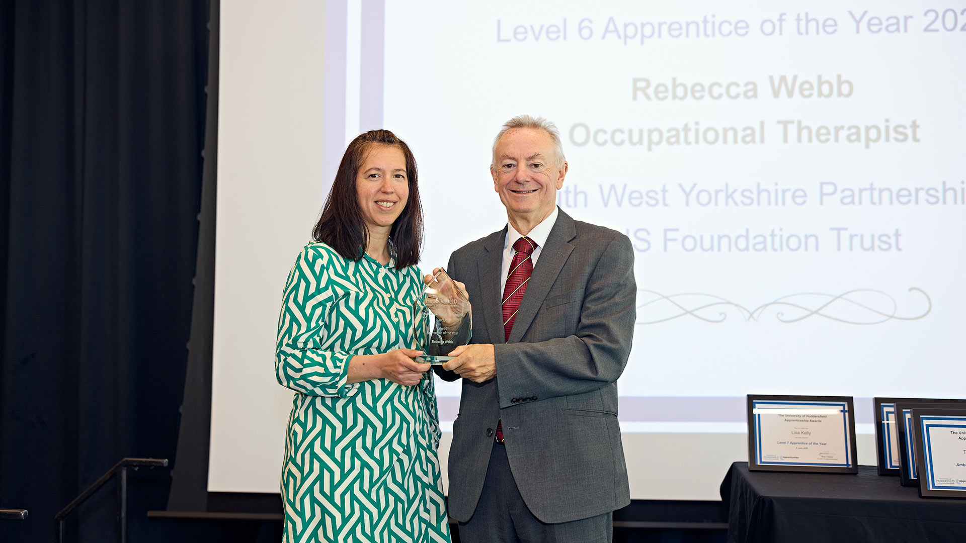 A woman receiving an award on stage